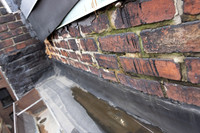 August 2021 - damaged bricks at south alley party wall and elevator shaft penthouse