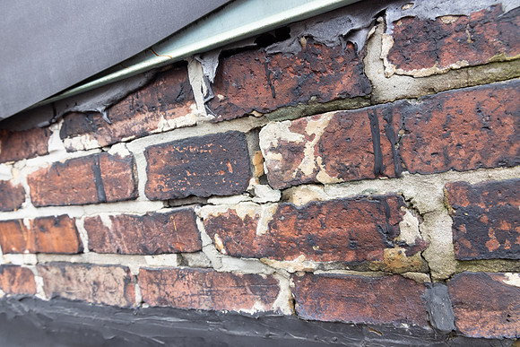 August 2021 - damaged bricks at south alley party wall and elevator shaft penthouse