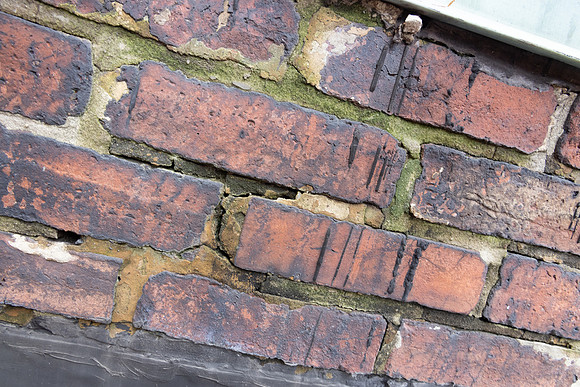 August 2021 - damaged bricks at south alley party wall and elevator shaft penthouse