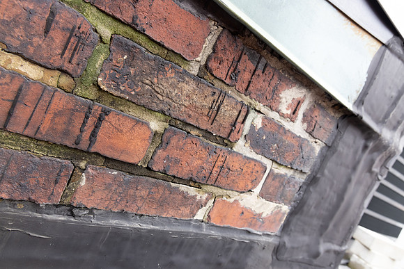 August 2021 - damaged bricks at south alley party wall and elevator shaft penthouse