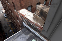 August 2021 - damaged bricks at south alley party wall and elevator shaft penthouse