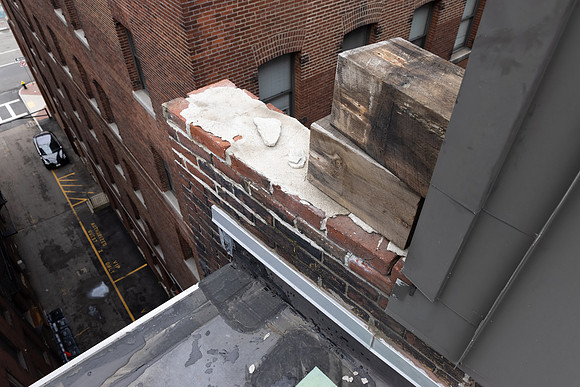 August 2021 - damaged bricks at south alley party wall and elevator shaft penthouse